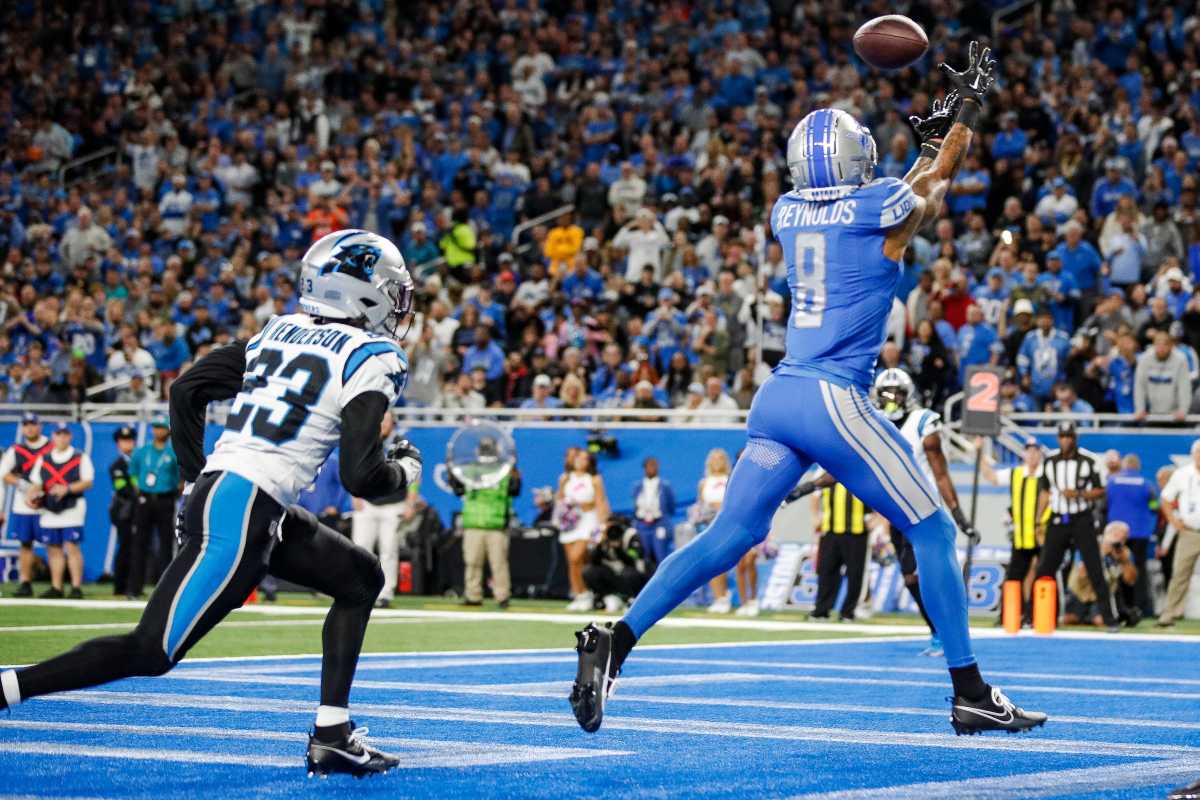 Josh Reynolds reaches his hands up to catch the ball in the endzone as Panthers cornerback CJ Henderson runs after him